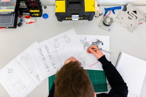 Student following safety practice while working in a technical workshop